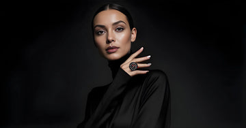 Woman wearing a black wearable ring watch, modern fashion accessory on black background